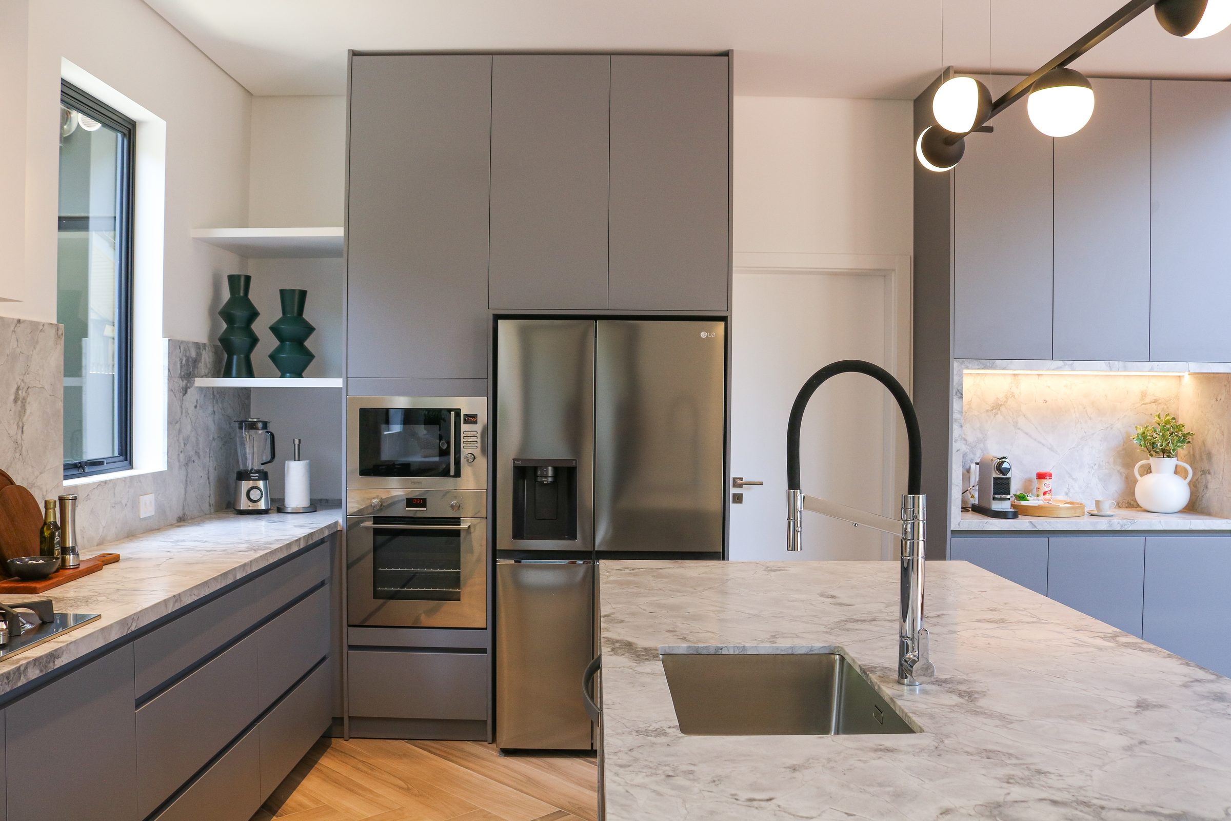 Casa Praia Mole, kitchen with tall cabinetry and marble island